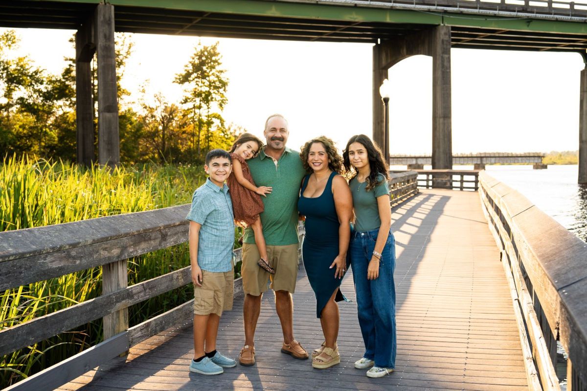 Dan and Angela Udy with their children on a waterfront boardwalk